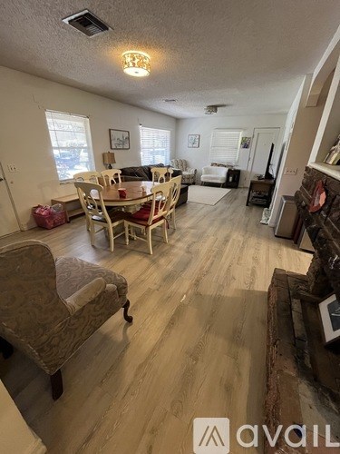 A living room with a dining table and chairs.