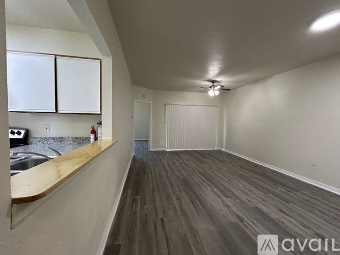 A kitchen with white cabinets and a stove top oven.