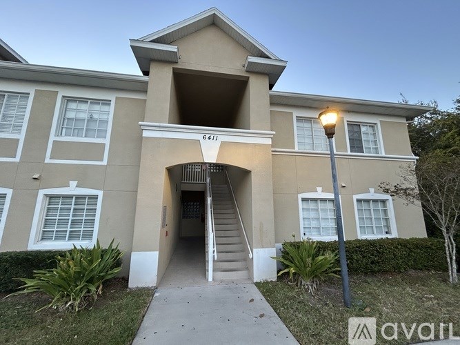 A room with wooden flooring and a white door.