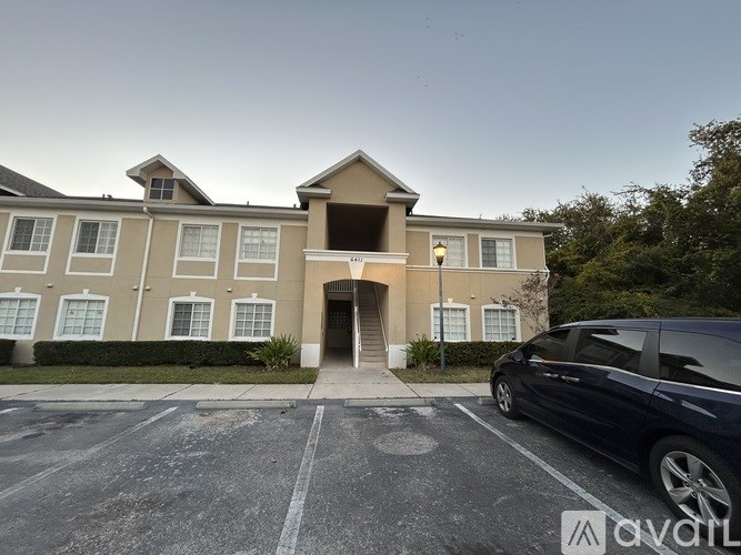 A room with a ceiling fan and a chandelier.