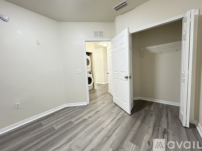 A room with a white door and a white wall.