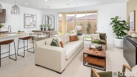 A living room with a white couch and a wooden coffee table.