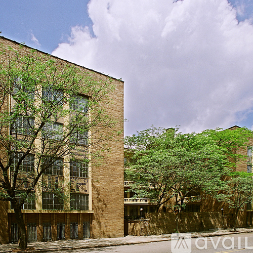 A tall building with a tree in front of it.