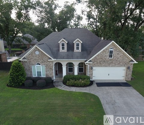 A house with a grey roof and a white garage door.