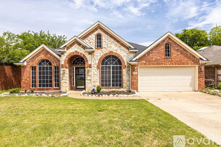 A house with a brick facade and a large front yard.