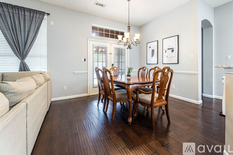 A dining room with a wooden table and chairs.