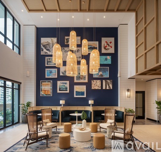 A living room with a blue wall and a white sofa.