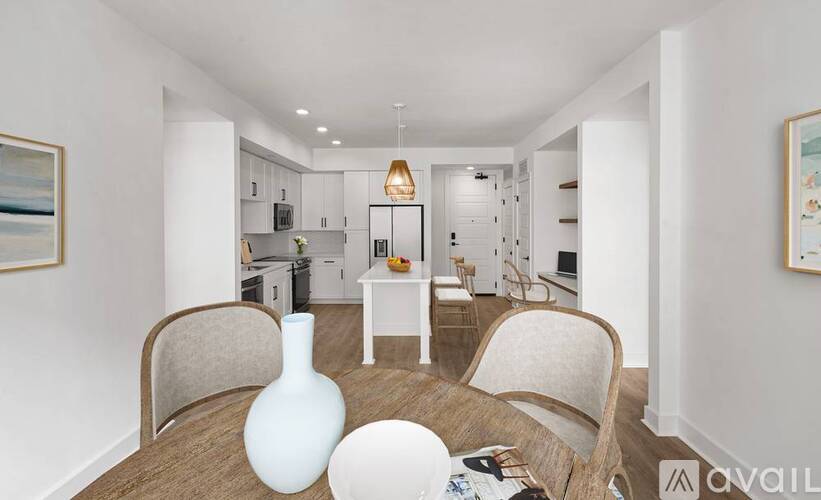 A modern living room with a dining table and chairs.