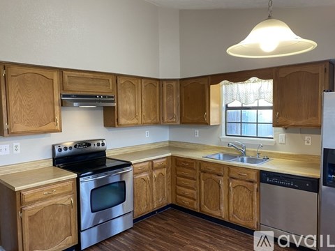 A kitchen with wooden cabinets and stainless steel appliances.