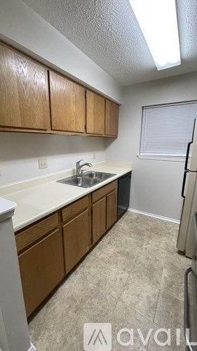 A kitchen with wooden cabinets and a white countertop.