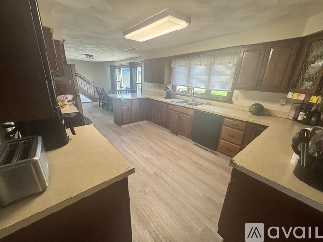 A kitchen with wooden cabinets and a white countertop.