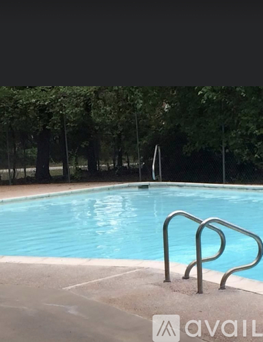 A pool with a metal ladder in the middle of it.