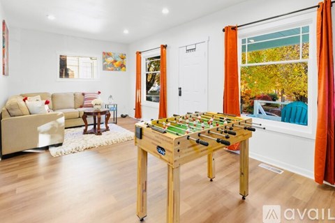 A foosball table sits in the middle of a living room.