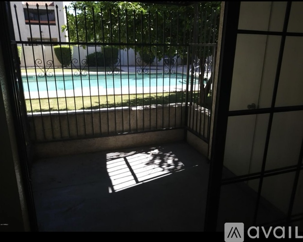 A pool seen through a fence.