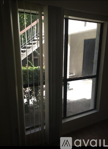 A view of a balcony through a sliding glass door.