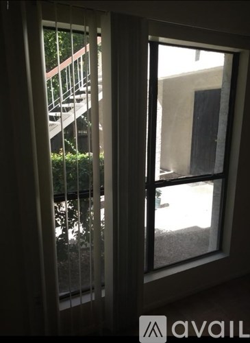 A view of a balcony through a sliding glass door.