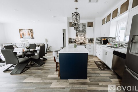 A modern kitchen with a dining table and chairs.