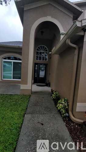 A house with a black door and a window is shown.