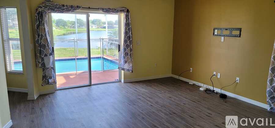 A room with a pool outside the window.