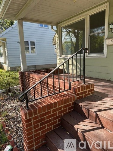 A house with a brick staircase leading to a door.