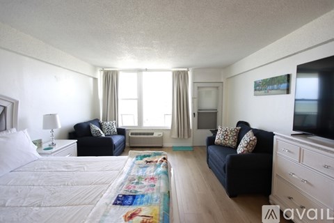 A bedroom with a large bed and a couch.
