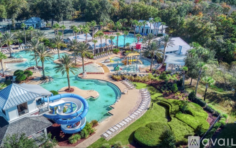 An aerial view of a water park with a large pool and a slide.