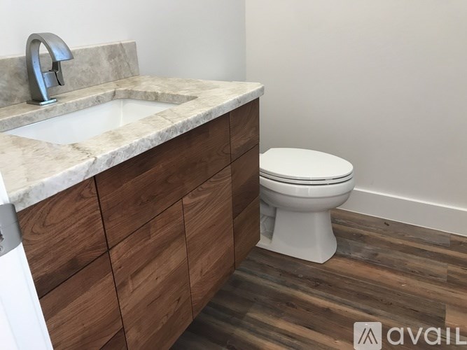 A white toilet sits next to a sink in a bathroom.