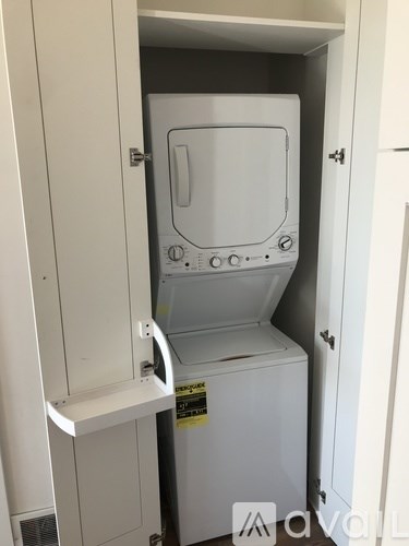 A white oven is built into a cabinet.