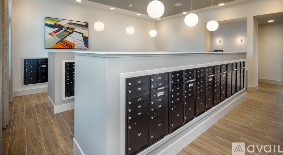 A row of mailboxes are lined up on a wall.