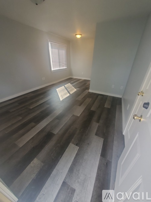 A room with wooden stairs leading to a door.
