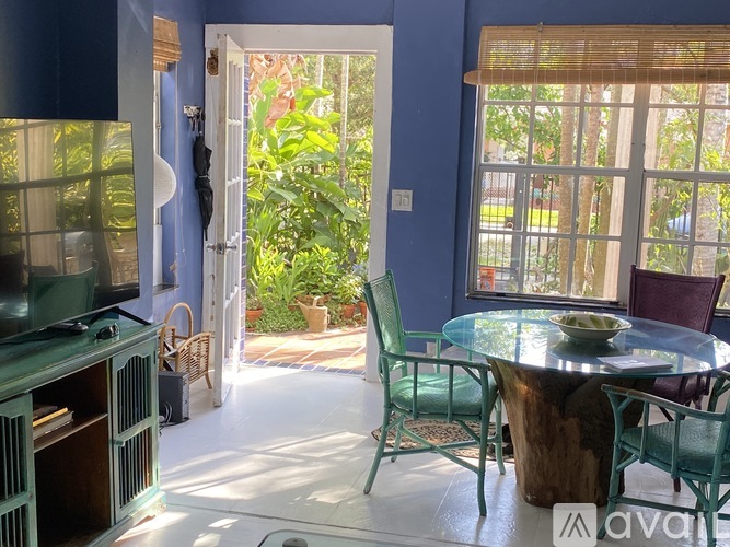 A living room with a glass table and chairs.