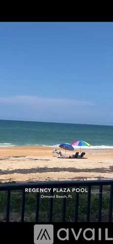 A beach scene with a pool and a beach umbrella.