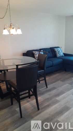 A dining area with a table and chairs.