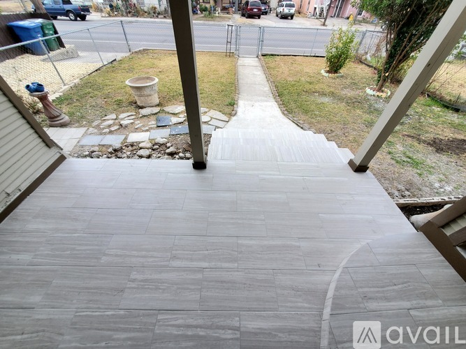 A stone pathway leads down to a grassy area.