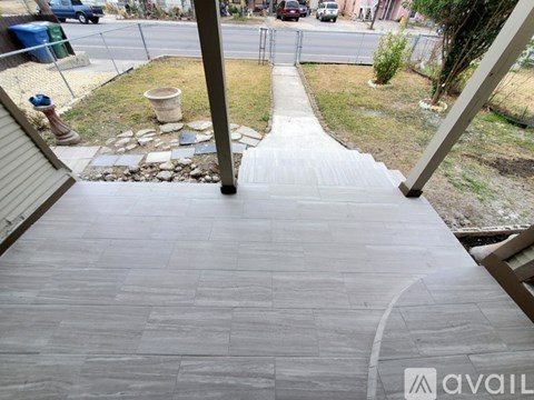 A stone pathway leads down to a grassy area.