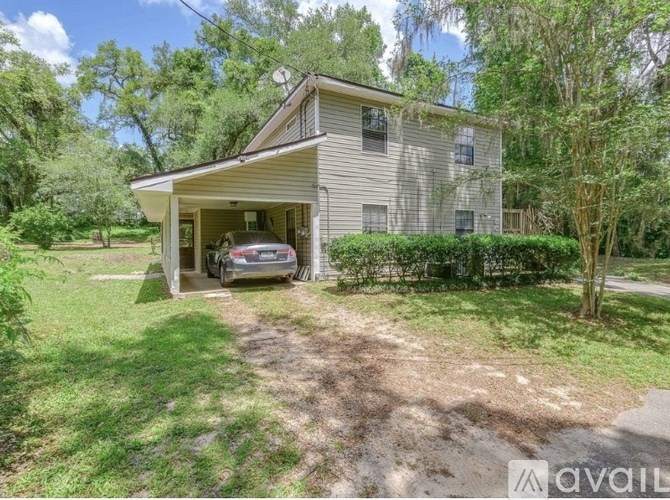 A house with a car in the garage is for sale.