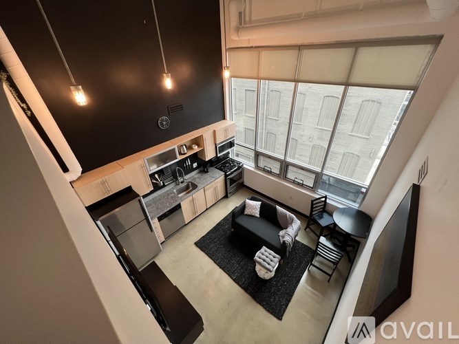 A modern kitchen with a large island and a view of the city.