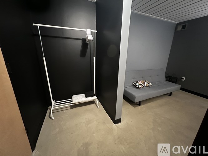 A room with a hanger and a bench.