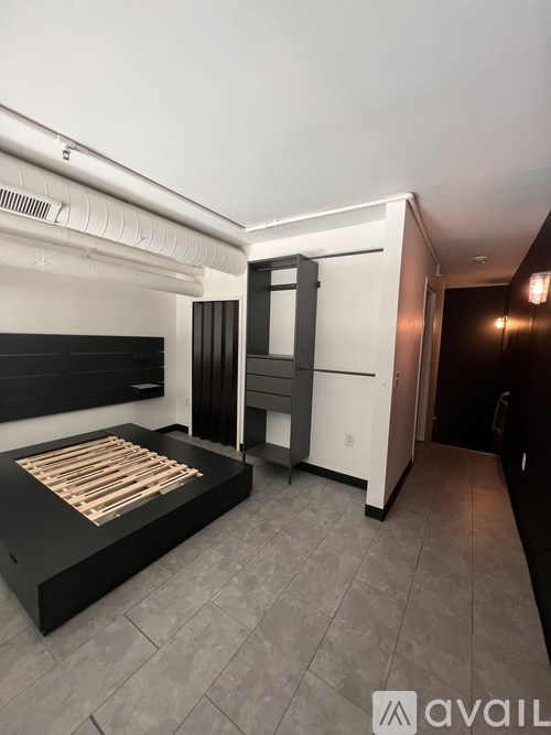 A bedroom with a bed, wardrobe, and a television.