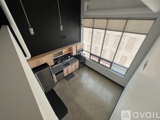 A room with a desk and a laptop on it.