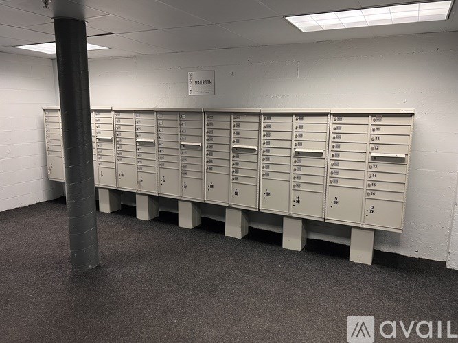 A row of mailboxes are lined up in a room.