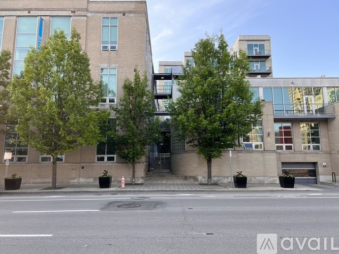 A street view of a building with a fire hydrant in front of it.