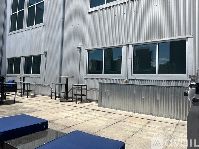 A patio area with tables and chairs outside a building.