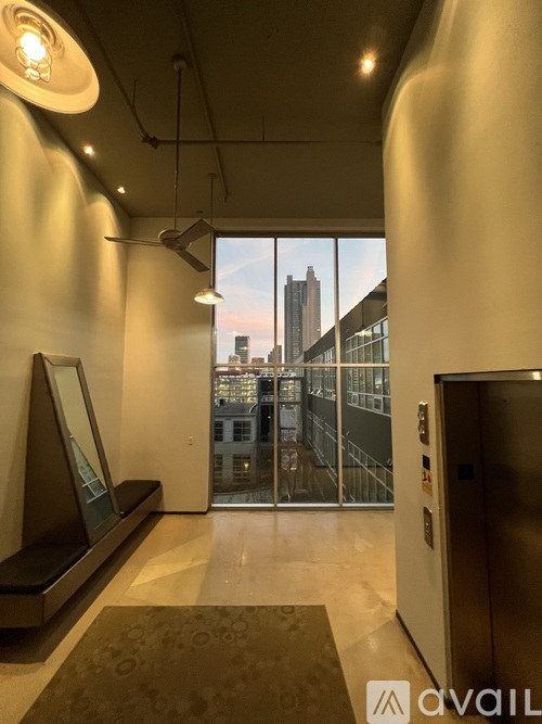A hallway with a large window overlooking a cityscape.