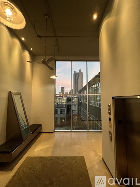A hallway with a large window overlooking a cityscape.