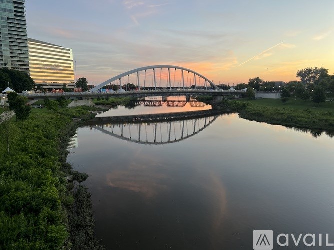 A bridge over a river with a building in the background.