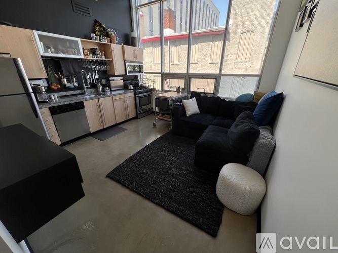 A kitchen with a black stove top oven and a black fridge.