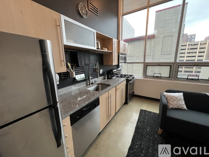 A modern kitchen with a refrigerator, stove, and sink.