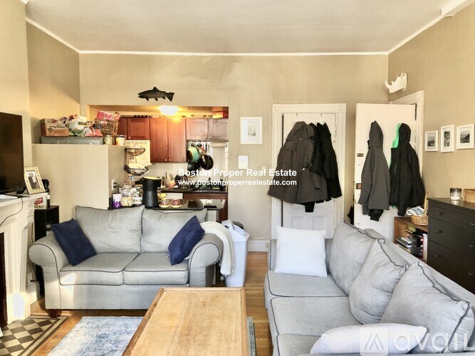 A living room with a grey couch and a coffee table.