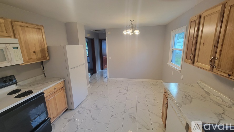 A kitchen with wooden cabinets and a black stove top oven.